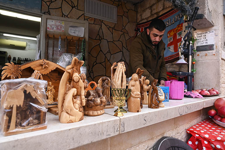 A local shopkeeper in Cana, Israel, waits to greet tourists in the town where tradition holds that Jesus performed his first miracle -- turning water into wine at the wedding at Cana. Tourism to Israel and the Holy Land has rebounded following the global pandemic and lockdowns that began in 2020, but the ongoing war between Russia and Ukraine has presented other setbacks.