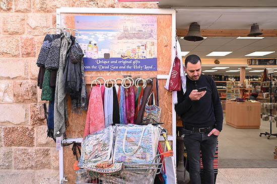 A local shopkeeper in Cana, Israel, waits to greet tourists in the town where tradition holds that Jesus performed his first miracle -- turning water into wine at the wedding at Cana. Tourism to Israel and the Holy Land has rebounded following the global pandemic and lockdowns that began in 2020, but the ongoing war between Russia and Ukraine has presented other setbacks.
