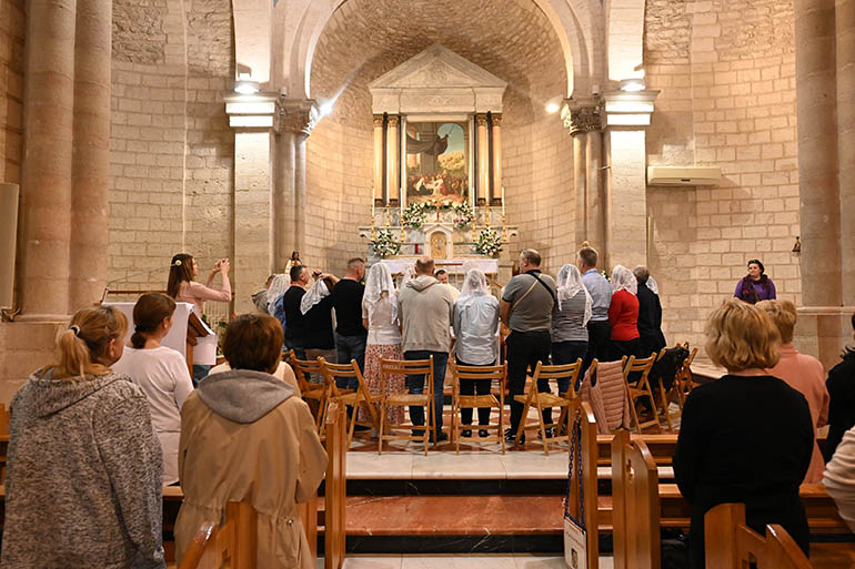 Couples take part in a renewal of wedding vows at the Catholic Church in Cana, Israel, where tradition holds that Christ turned water into wine at a wedding. Tourism to Israel and the Holy Land has rebounded following the global pandemic and lockdowns that began in 2020, but the ongoing war between Russia and Ukraine has presented other setbacks.