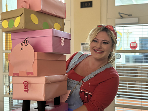 Ashley Sacks, Little Flower Parish director of Development, holds the piggy ballot boxes ready to be filled with the votes for the People’s Choice award at the parish school's Pig-Nic, Jan. 29, 2023.