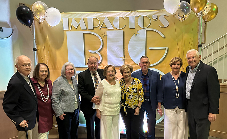 Ernesto and Adelita Roche, fourth and fifth from left, pose with other founders and longtime volunteers with Impactos de Cristiandad during the ministry's 50th anniversary celebration, Feb. 11, 2023 at Blessed Trinity in Miami Springs.