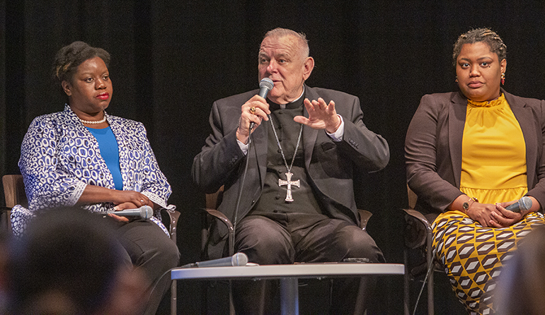 Archbishop Thomas Wenski said today's immigrants are "modern-day Lazarus" during a panel discussion on recent migration in South Florida. The discussion was hosted by The Miami Herald / El Nuevo Herald Feb. 23, 2023 at the Wolfson campus of Miami Dade College. From left are fellow panelists Guerline Jozef, founder and executive director of the Haitian Bridge Alliance, and Krystina Francois, co-director of CUSP (Communities United for Status and Protection).
