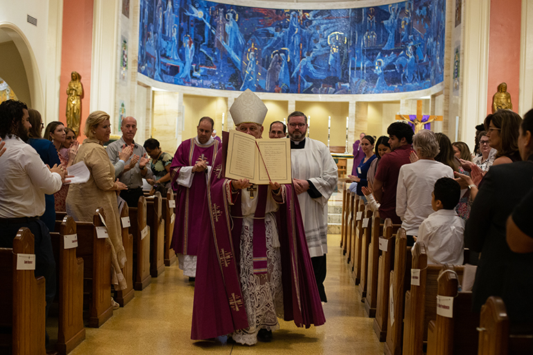 Archbishop Thomas Wenski shows the congregation the Book of the Elect as he welcomed 453 catechumens who will soon join the Catholic Church during two Rite of Election ceremonies held at St. Mary Cathedral the Sunday after Ash Wednesday, Feb. 26, 2023.