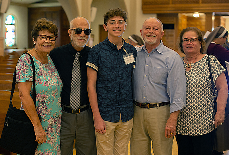 Catechumen Anthony Michael Quinones, 13, poses with his grandparents, Eileen and Sam Quinones, and his sponsors, Abner and Rita Garcia. He was one of 453 catechumens welcomed by Archbishop Thomas Wenski as among the "elect" in the Catholic Church during two Rite of Election ceremonies held at St. Mary  Cathedral the Sunday after Ash Wednesday, Feb. 26, 2023.