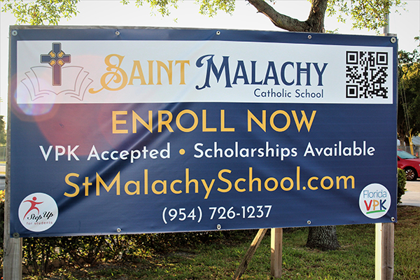 A sign on busy University Drive and N.W. 61st Street in Tamarac announces the reopening of St. Malachy Catholic School.