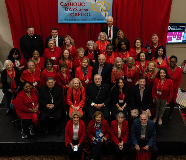 At Catholic Days in the Capitol breakfast, Archbishop Thomas Wenski and Auxiliary Bishop Enrique Delgado take a photo with members of the Archdiocese of Miami who traveled to Tallahassee to lobby state legislators and senators on issues of importance to the Catholic Church.