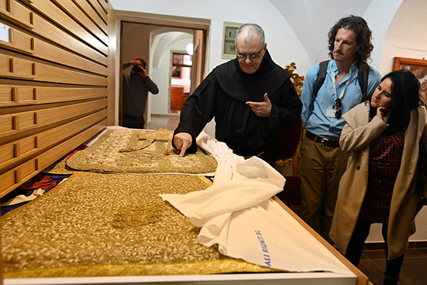 Father Stéphane Milovitch, director of the Cultural Heritage Office for the Custodia Terrae Sanctae in Jerusalem, points to clerical vestments worn at Napoleon's wedding. This chasuble was part of a collection of vestments that the bishop of Paris, France, wore for the marriage of Napoleon II with the Empress Eugenie and which the empress later donated to the Church in the Holy Land.