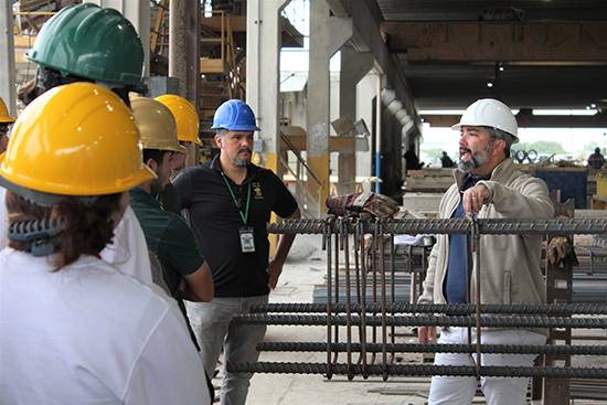 Luis Compres, project consultant at Coreslab Structures in Medley, shows students and teachers from Immaculata-La Salle High's STEAM engineering program steel rebars, cabling used as a tension device in reinforcing concrete. The students and teachers were given a tour of the grounds of Coreslab Nov. 17, 2022. Coreslab is a leading producer of precast/prestressed concrete products and part of the construction team building Immaculata-La Salle's new athletic facilities.