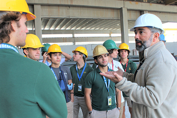 Luis Compres, project consultant at Coreslab Structures in Medley, answers questions from students of Immaculata-La Salle High's STEAM engineering program during their tour of the grounds of Coreslab, Nov. 17, 2022. Coreslab is a leading producer of precast/prestressed concrete products and part of the construction team building Immaculata-La Salle's new athletic facilities.