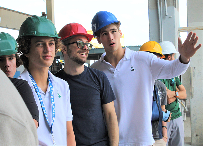 Students from Immaculata La Salle High's STEAM engineering program watch construction workers at different stations. Immaculata-La Salle students went on a tour of the grounds of Coreslab Structures in Medley, Nov. 17, 2022. Coreslab is a leading producer of precast/prestressed concrete products and part of the construction team building Immaculata-La Salle's new athletic facilities.