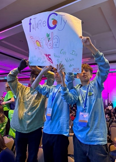 Eighth graders from St. Hugh School in Miami cheer on their group mates at the  Future City international contest in Washington, D.C in February 2023, where the group placed fourth. Earlier in the year, they won first place in the Tampa Bay, Florida regional contest.