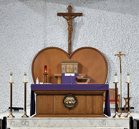 Wood paneling behind the altar takes the shape of a heart.