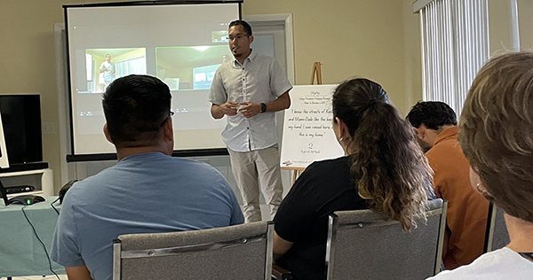 Julio Calderon, lead student organizer with ABIC and TheDream.US, speaks to those gathered at the Poveda Center in Miami for the presentation on Dreamers, March 25, 2023.