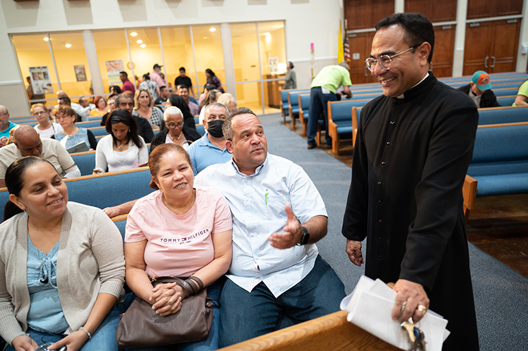Father Wilfredo Contreras, pastor of San Isidro Church in Pompano Beach, speaks with parishioners who attended the BOLD Justice assembly held March 30, 2023 at San Isidro.