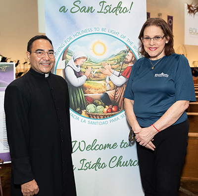 Father Wilfredo Contreras, pastor of San Isidro Church in Pompano Beach, poses with parish secretary Esperanza Puerta, a native of Venezuela who shared her story at the BOLD Justice assembly held March 30, 2023, at the church.