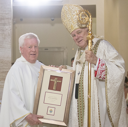 Father Edmond Prendergast, pastor of St. Bonaventure Church in Davie, is congratulated by Archbishop Thomas Wenski on his 50th anniversary in the priesthood, a recognition that took place during the chrism Mass at St. Mary Cathedral, April 4, 2023.