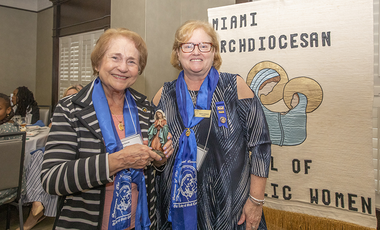 Karen Lorenzen, president of the Miami Archdiocesan Council of Catholic Women (MACCW), gives a statue of the Virgin Mary to Annya Fernandes Koszas, this year’s recipient of the Our Lady of Good Counsel award. The award was given during the 65th anniversary celebration of the MACCW, on April 29, 2023 in Fort Lauderdale.