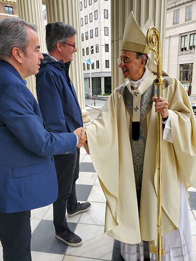 David Prada, senior director of the Office of Building and Property at the Archdiocese of Miami, shakes hands with Baltimore Archbishop William Lori at the 27th annual Conference for Catholic Facility Management (CCFM) in Baltimore, Maryland, held April 30-May 3, 2023.