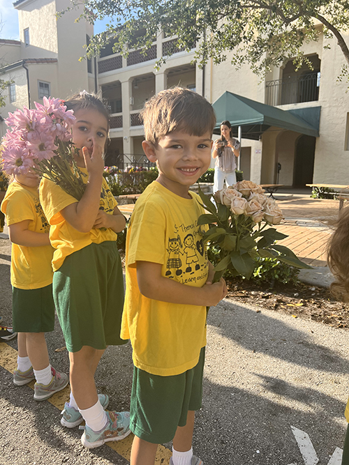 Students in pre-K through kindergarten bestow flowers upon the statue of the Virgin Mary in the school’s yard during St. Theresa School's celebration of the month of Mary, May 1-9 and 12, 2023.