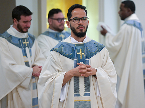 Newly ordained Father Saul Araujo prepares to join fellow priests in the sanctuary after Archbishop Thomas Wenski ordained him and four others men to the priesthood for the Archdiocese of Miami, May 13, 2023, at St. Mary Cathedral.