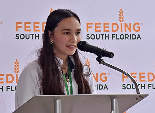 Leila Murray thanks Feeding South Florida in front of students, staff and faculty at St. Thomas Aquinas High School, where she's a student. The event was the unveiling of her artwork May 31, 2023, at the Fort Lauderdale school.