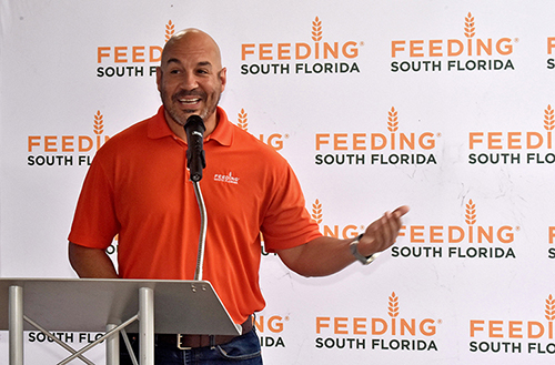 CEO Paco Velez of Feeding South Florida praises student Leila Murray's artwork for his organization, in an unveiling ceremony May 31, 2023, at St. Thomas Aquinas High School, Fort Lauderdale.