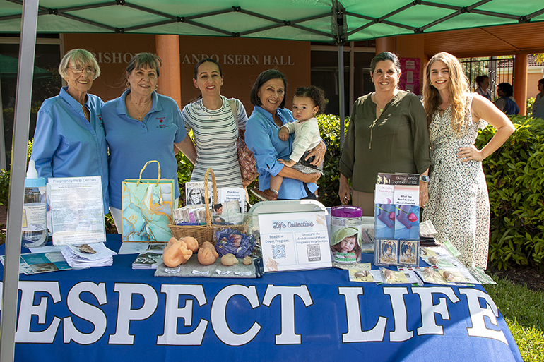 Representatives from the Archdiocese of Miami Respect Life Ministry take part in Life Collective, a pro-life art exhibition at Our Lady of Lourdes Church in Miami, May 21, 2023. From left: Ana Perez-Nodarse, counselor; Annie Ruggiero, counselor; Victoria Velez member, Our Lady of Lourdes Respect Life ministry; Pat Perez, Respect Life representative; Camilo Velez, son of Victoria; Belkys Rodriguez, assistant director of Respect Life; and Mackenzie Fraser South Broward program coordinator.