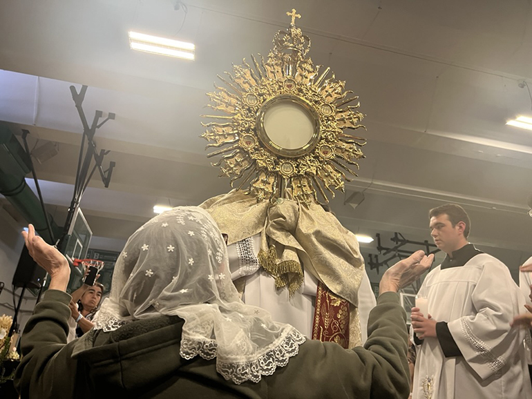 Attendees adore Jesus in the Blessed Sacrament at the culmination of the “I Will Always Be With You” Eucharistic Retreat at St. Brendan High School, June 10, 2023.