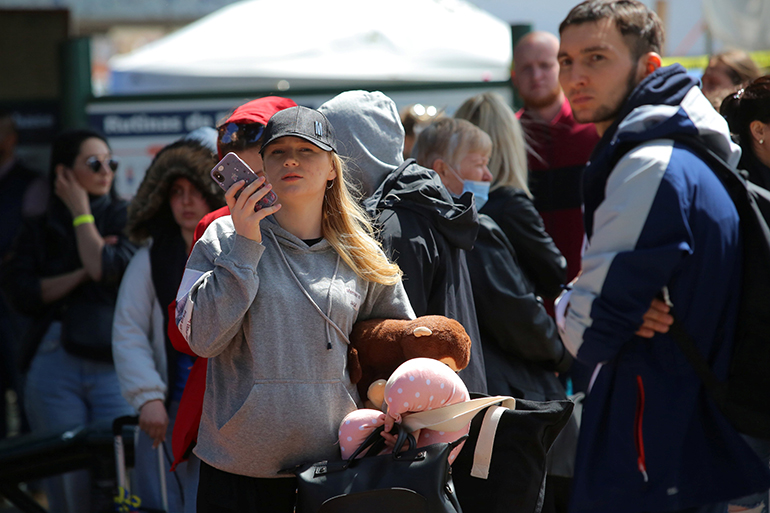 Ukrainian refugees seeking asylum in the United States wait in line April 22, 2022, to board a bus in Tijuana, Mexico. Since Russia's invasion of Ukraine Feb. 24, 2022, over 271,000 Ukrainian refugees have been admitted to the United States, according to the Department of Homeland Security. Some refugees have found a safe haven in West Virginia with the help of Catholic parishioners in the Diocese of Wheeling Charleston. (OSV News photo/Jorge Duenes, Reuters)