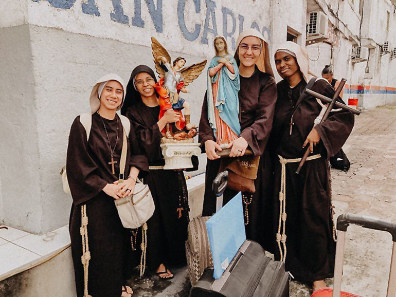 Members of the Sisters Poor of Jesus Christ pose with statues of St. Michael the Archangel and Mary and a crucifix after arriving in El Salvador after leaving Nicaragua July 3, 2023. The community announced that day they left their post in Nicaragua, becoming the latest community of women religious to leave the country where the regime of President Daniel Ortega has cracked down on the Catholic Church. (OSV News photo/courtesy Sisters Poor of Jesus Christ via Facebook)