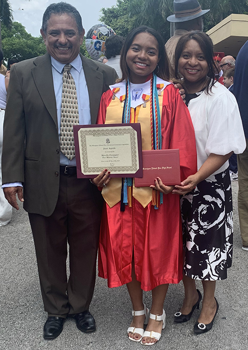 Jaime, Jamie, and Janeth Argüello smile for the camera after Jamie’s graduation from Msgr. Edward Pace High School on May 26, 2023.
