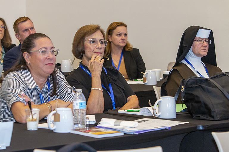 Paying attention to speakers at the all-principals meeting held before the start of the 2023-24 school year, Aug. 4, 2023, at St. Brendan High School, from left:  Lisette Reina-Naranjo of St. Michael the Archangel School, Miami; Bertha Moro of St. Patrick School, Miami Beach; and Carmelite Sister Rosalie Nagy of St. Theresa School, Coral Gables.