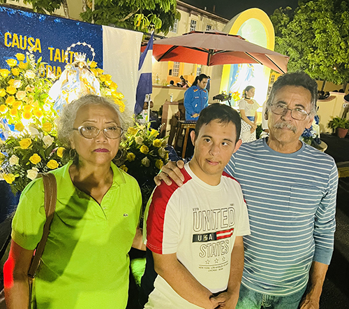 Celia Álvarez, Jairo Blandón and their son Jairo Jr. enjoy the annual "Gritería Chiquita" to the Virgin Mary, a reminder of their traditions and devotional values, after the Mass that was celebrated Aug. 15, 2023 at St. John the Church Apostle, Hialeah.