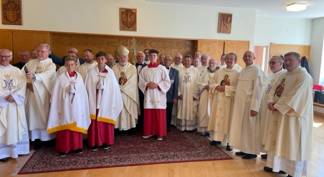 Archbishop Thomas Wenski, center, poses with some of the priests and altar servers who took part in the closing Mass of the annual walking pilgrimage to the National Shrine of Our Lady of Czestochowa, in Doylestown, Pennsylvania, Aug. 27, 2023.