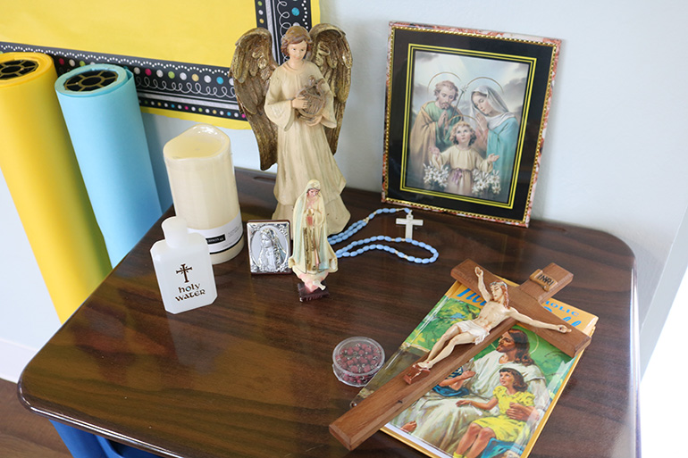 Religious items including rosary beads and holy water are placed on a table at St. Malachy School, a symbol of the school's special Catholic environment that makes it different from public school. The Tamarac school is reopening for the 2023-24 school year after closing in 2009.