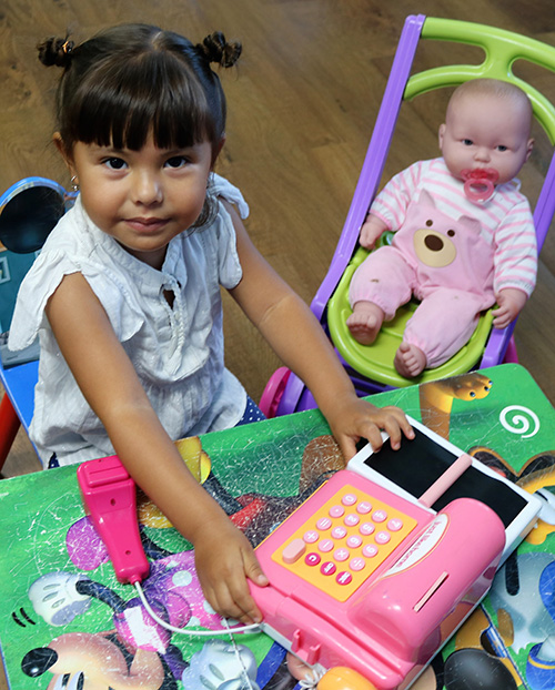 Luna Rico, 3, while visiting St. Malachy School with her mother, Jennifer Rico, went straight for the dolls and a pink phone in one of the classrooms. The Tamarac school is reopening for the 2023-24 school year after closing in 2009.