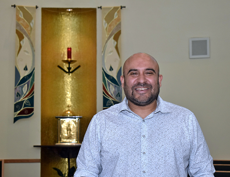 Richard Carrillo pauses in front of the altar in the chapel of St. John Neumann Church, Miami, where he directs the choir. He’ll present the "Mass of the Americas" Oct. 3, 2023, at Epiphany Church, also in Miami.