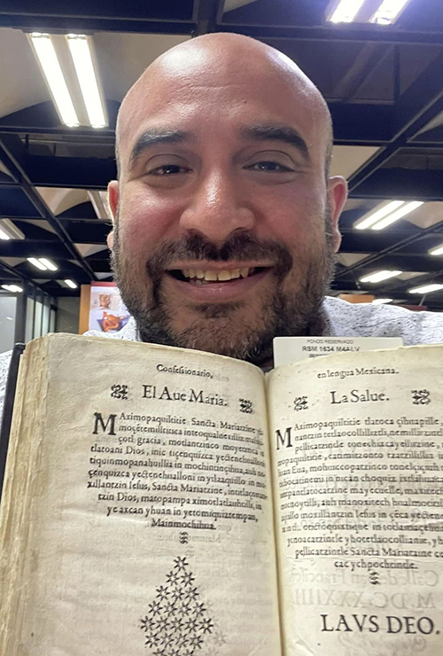 Richard Carrillo shows a centuries-old text for the Ave Maria in Nahuatl, the language of his Aztec ancestors, which he saw this summer on a research trip to Mexico City. Nahuatl will be one of the languages of the "Mass of the Americas," which Carrillo will present Oct. 3, 2023, at Epiphany Church in Miami.