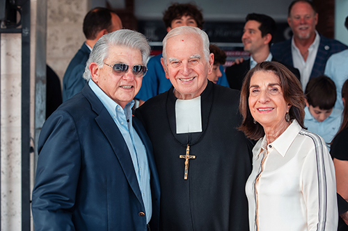 Maximo Alvarez, Marist Brother Kevin Handibode, and Esther Alvarez pose for a photo after announcing the Alvarez family's transformational gift to Christopher Columbus High for the full renovation of the school’s original main entrance and “A” Building, Sept. 13, 2023.