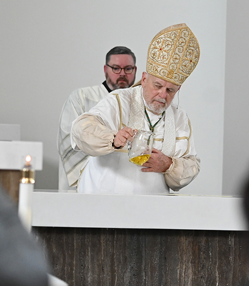 Archbishop Thomas Wenski pours oil of chrism, anointing the altar during the dedication of St. Agnes Church, Key Biscayne, Sept. 15, 2023.