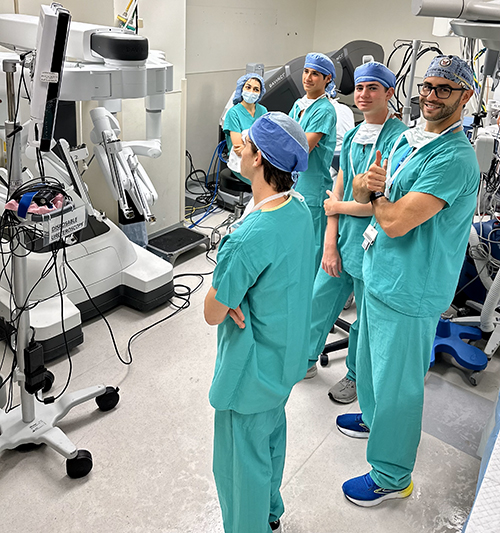 Participating in Intuitive da Vinci robotic surgery simulator practice, from left: Cardinal Gibbons High School student Jack Perez; Dr. Nathan Schoen, cofounder of the Summer Surgical Scholars program and chief resident, University of Miami at Holy Cross; Cardinal Gibbons High School student Vincent Perez; Lake Nona High School student Javier Otero; and Dr. Mahsa Shariat.