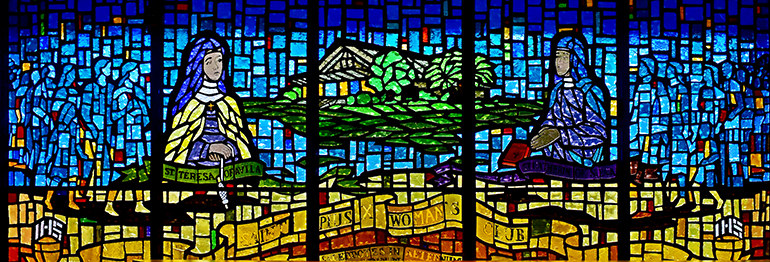 Panoramic window shows two favorite saints of St. Pius X's Women’s Club: St. Teresa of Avila on the left, and St. Catherine of Siena.