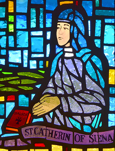 St. Catherine of Siena was a 14th century mystic who prodded Pope Gregory XI to return to Rome from Avignon, France. But Muriel Conroy notes that due to a production error, the "e" is missing in the stained-glass window designed by her and other members of St. Pius X's Women's Club.