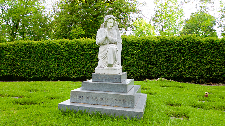 An angel's statue watches over the Garden of the Holy Innocents at Our Lady of Mercy Cemetery in Doral. The Footprints in the Garden campaign enables the faithful who donate 0 to purchase a marker to memorialize and honor children who perished as newborns or before birth.
