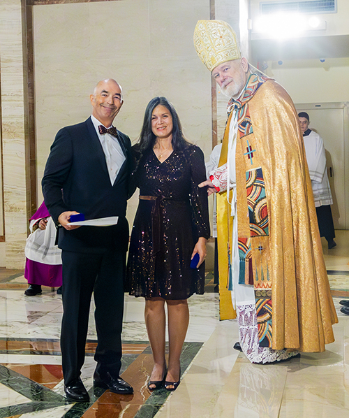 Juan and Natalie Bauta receive the Primum Regnum Dei honor from Archbishop Thomas Wenski during the Archdiocese of Miami's 65th anniversary vespers service, Oct. 22, 2023, at St. Mary Cathedral.