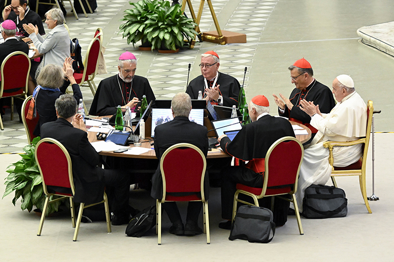 Pope Francis and leaders of the assembly of the Synod of Bishops applaud at the conclusion of the gathering's last working session Oct. 28, 2023, in the Paul VI Hall at the Vatican. (CNS photo/Vatican Media)