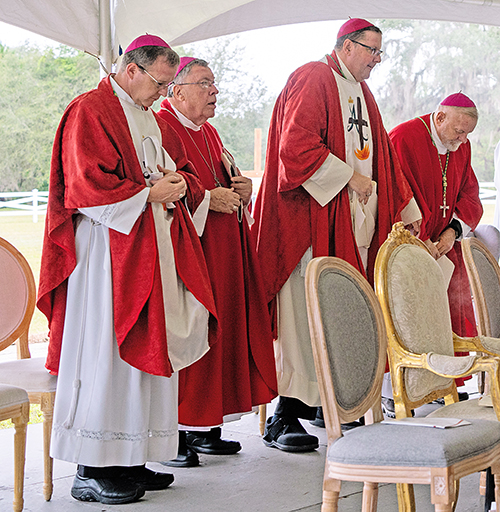 Bishop Erik Polhmeier of St. Augustine, left, Bishop Emeritus Robert Baker of Birmingham, Alabama, Bishop Gregory Parkes of St. Petersburg and Archbishop Thomas Wenski of Miami participate in Mass in Tallahassee Oct. 12, 2023, marking the end of the diocesan phase of the cause for canonization of Antonio Inija and the 57 companions. Nine U.S. dioceses united for the cause of the martyrs who include indigenous peoples and religious clergy.