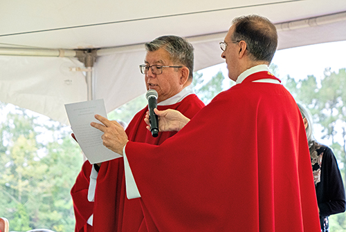 Father Maurice Henry Sands, left, takes the oath affirming he carried out his responsibilities "true and correct" as vice-postulator of the canonization cause of Antonio Inija and the 57 companions with Father Timothy Lindenfelser, pastor of St. Anastasia Parish in St. Augustine. Father Sands, director of the National Black and Indian Mission Office in Washington, D.C., is a native indigenous person in Canada and United States.