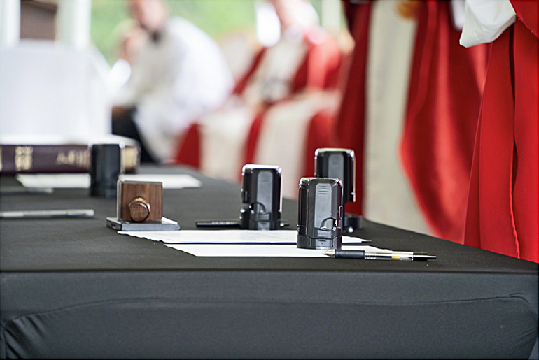 On this table are the seals to be used by the vice-postulators, notary, episcopal delegates, promotors of justice, and bishop of competency. Each member of the commissions for the cause of canonization for Antonio Inija and the 57 companions sign and seal documentation that will be sent to the Dicastery for the Causes of Saints in Rome.