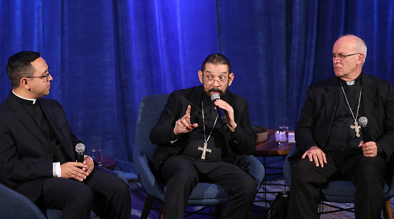 Bishop Daniel E. Flores of Brownsville, Texas, answers a question from a reporter at a news conference during a Nov. 14, 2023, session of the fall general assembly of the U.S. Conference of Catholic Bishops in Baltimore. Also pictured are Father Iván Montelongo, a priest of the Diocese of El Paso, Texas, Bishop Kevin C. Rhoades of Fort Wayne-South Bend, Ind. The three were asked their experiences at the Synod on Synodality, which took place in Rome Oct. 4-29. (OSV News photo/Bob Roller)
